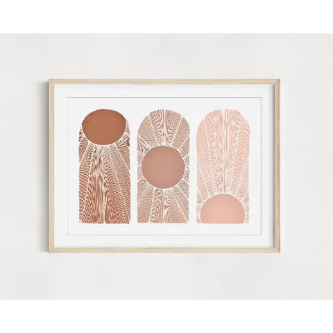 Framed abstract art print with geometric shapes on a white wall