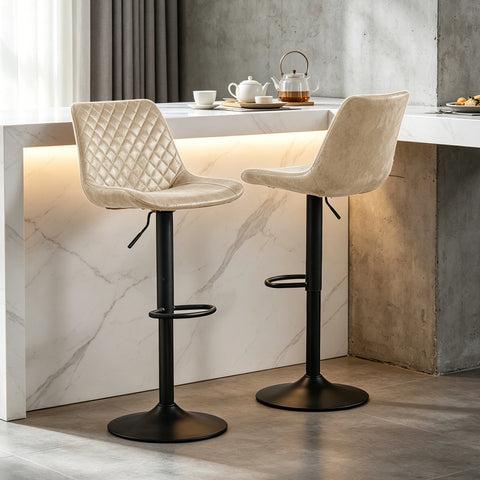 Two beige suede adjustable swivel bar stools at a breakfast bar