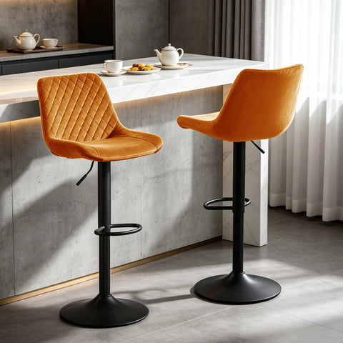 Two orange velvet adjustable swivel bar stools at a breakfast bar