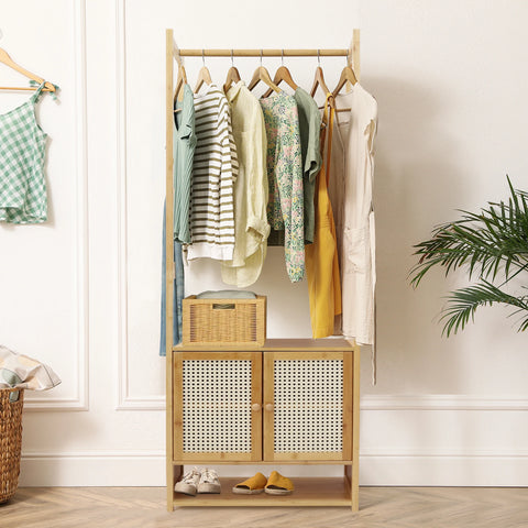 Bamboo clothes stand with a rattan-fronted cabinet, hung with clothes