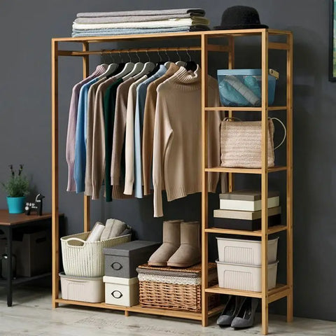 Bamboo garment rack with a curtain, hung with clothes and storage boxes