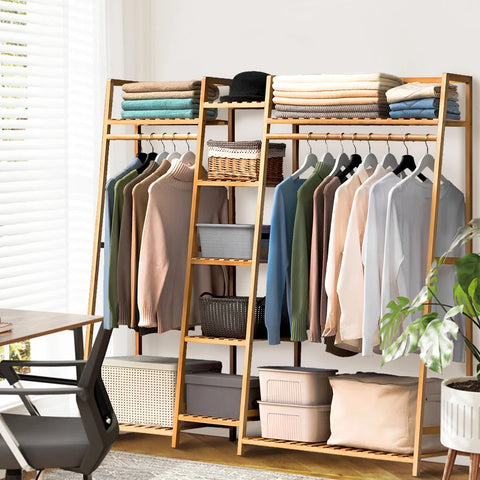 Bamboo ladder garment rack with storage baskets on the lower shelves