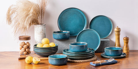 Blue reactive glaze dinner set arranged on a kitchen counter