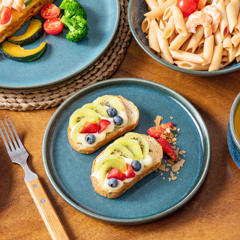 Teal reactive glaze plates served with food on a woven mat