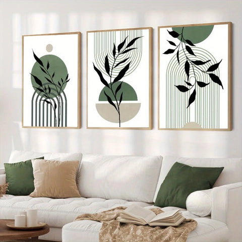 Boho sage green prints, set of three leaf designs framed above a white sofa