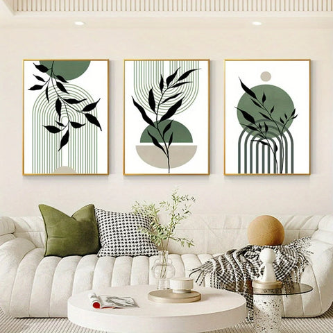 Three framed botanical prints above a sofa with cushions and a coffee table