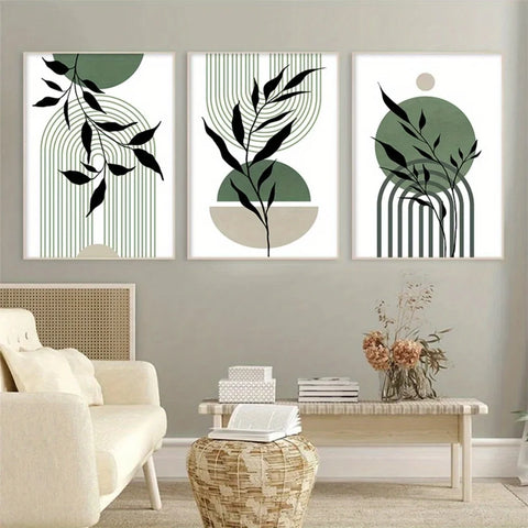 Set of three sage green abstract prints above a sofa and coffee table