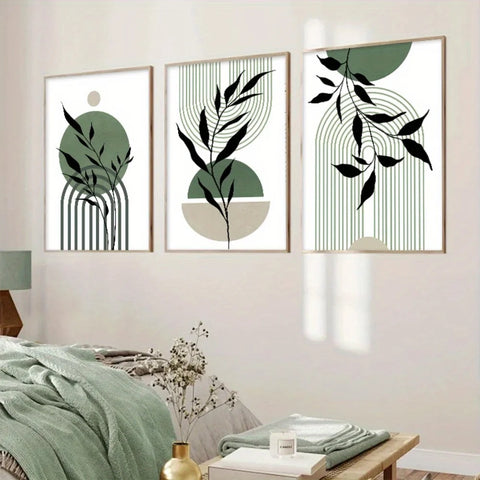 Three sage green and black abstract prints on a white wall