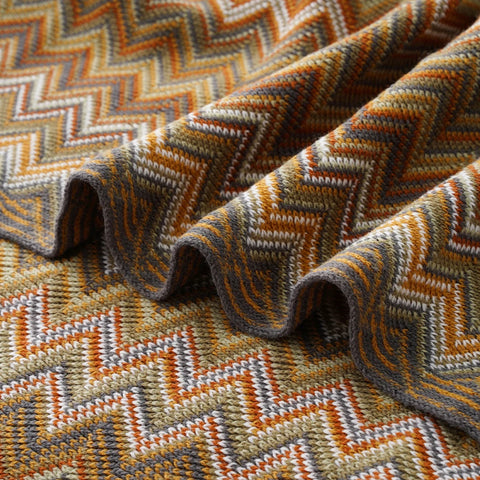 Close-up of the mustard chevron knit in soft folds