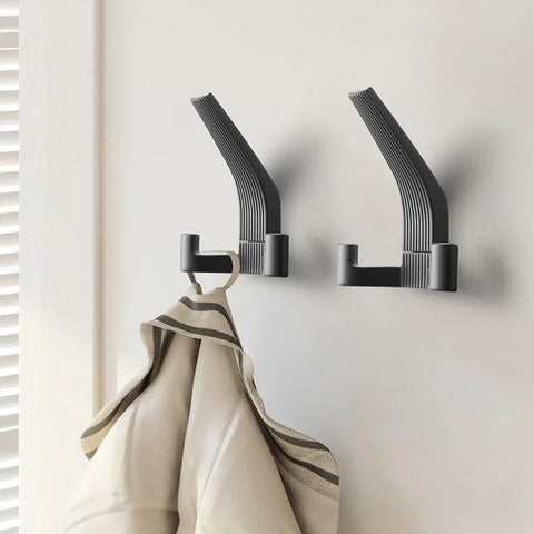 Black brushed metal wall hooks with a hanging robe