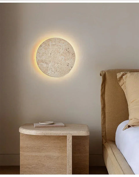 Cave stone wall light above a bedside table