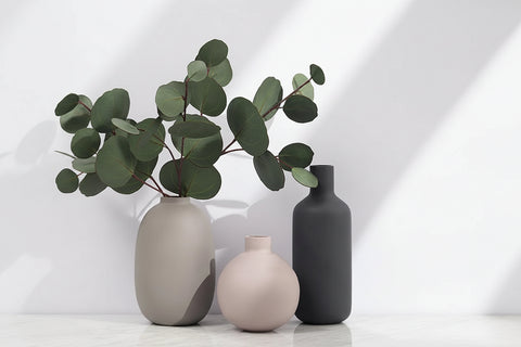 Three ceramic table vases with eucalyptus stems