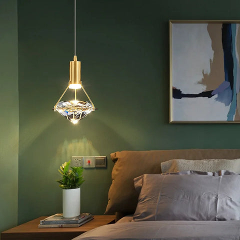 Copper and crystal pendant light in a green bedroom