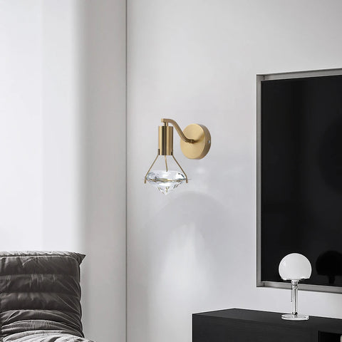 Copper and crystal wall light beside a television