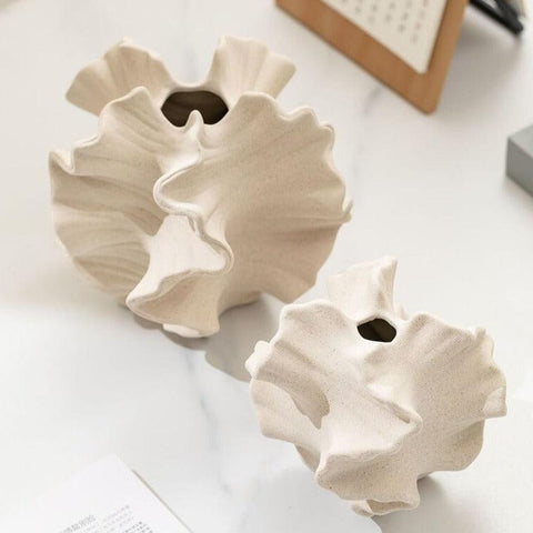 Coral ceramic vases seen from above, showing the narrow openings