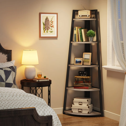Corner ladder bookcase in a bedroom beside a bedside lamp