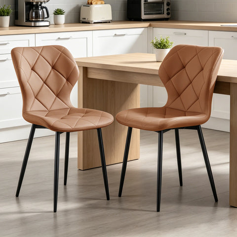 Two coffee curved back dining chairs at a wooden table