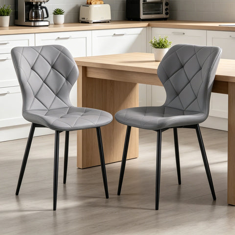 Two grey curved back dining chairs at a wooden kitchen table