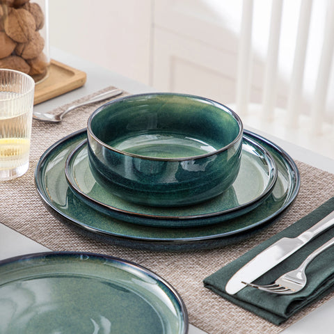 Curved edge green plates and bowls stacked together