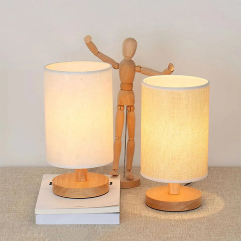 Two cylinder bedside lamps with a wooden artist's figure