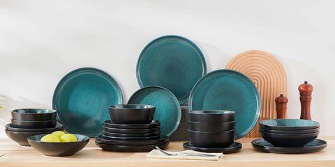 Black reactive glaze plates and bowls stacked