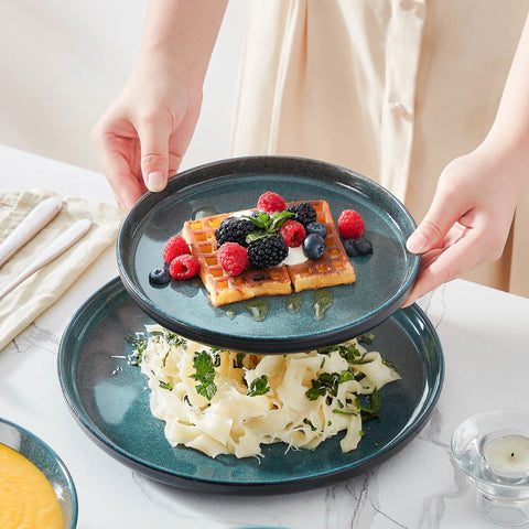 Holding a blue reactive glaze plate served with food