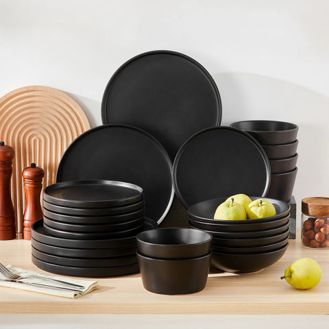 Dark reactive glaze dinner set in black, plates and bowls stacked