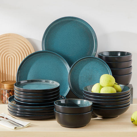 Dark reactive glaze dinner set in blue, plates and bowls stacked