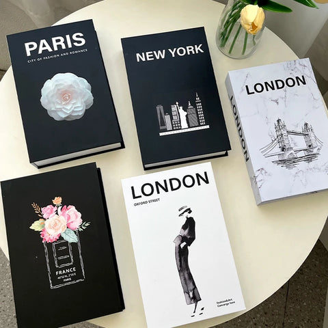 Decorative book boxes styled with flowers on a table