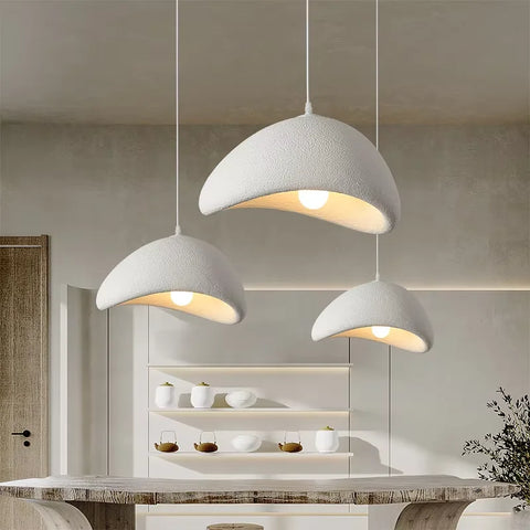 Three dome pendant lights over a kitchen counter
