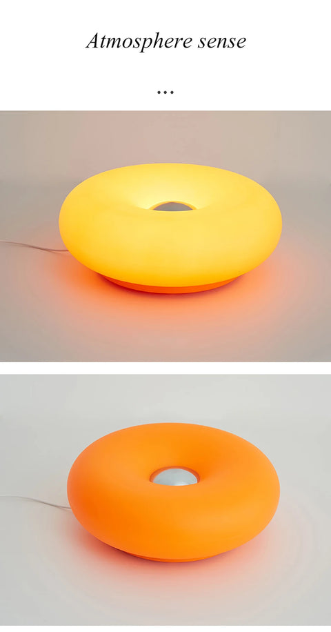 Donut table lamp in orange, shown lit and unlit