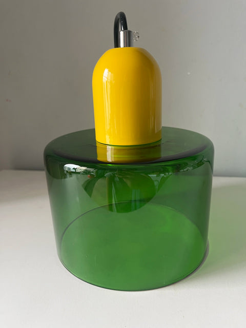Emerald glass pendant light with a mustard cap, close-up