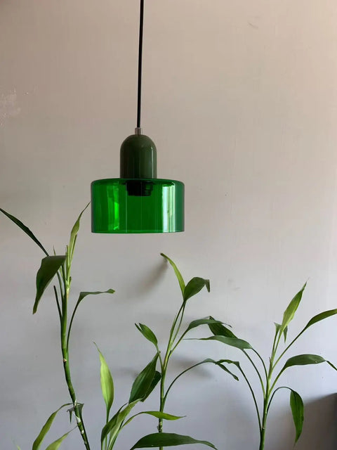 Emerald green glass pendant light above a plant