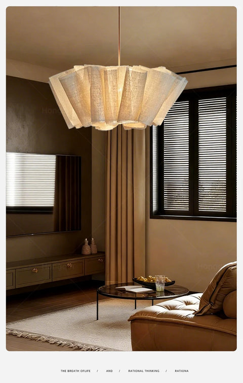 Pleated fabric chandelier in a bedroom with floor-length curtains
