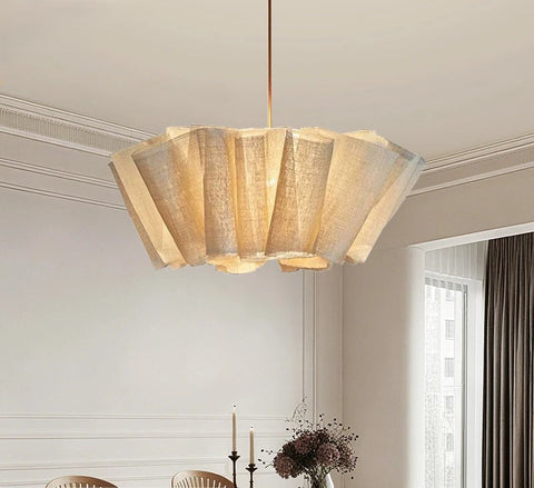 Pleated fabric chandelier in a living room beside a window