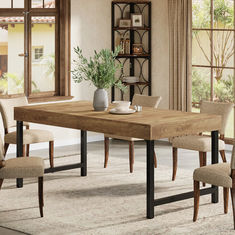 Rustic brown dining table laid for a meal with four chairs
