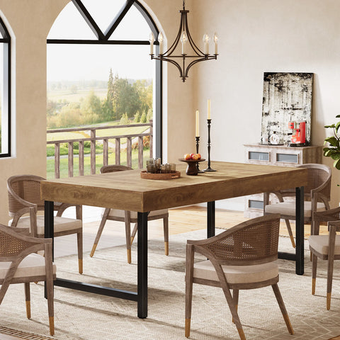 Farmhouse dining table with four chairs beside a window and a plant