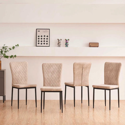 Four beige faux suede dining chairs along a wall
