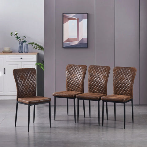 Four brown faux suede dining chairs in a living space
