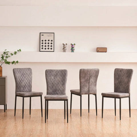 Four grey faux suede dining chairs along a wall