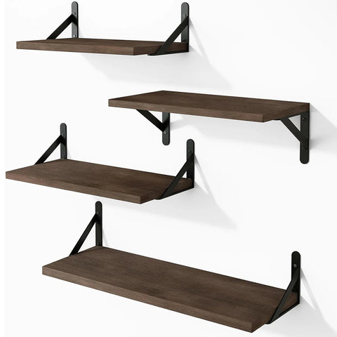Floating shelves in walnut with black brackets on a dark wall