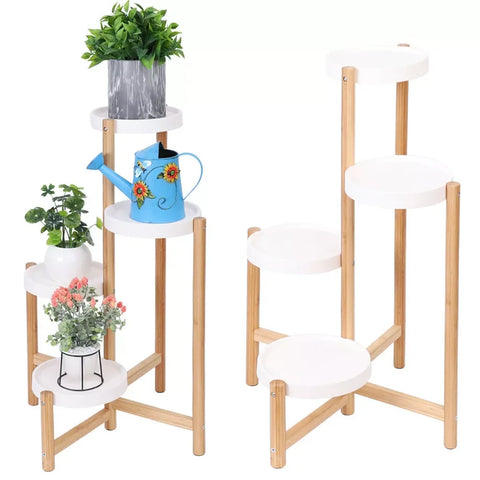Four-tier bamboo plant stand with white pots on a plain background