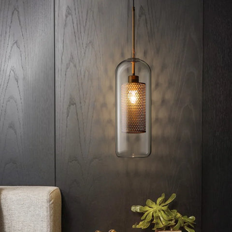 Smoke glass globe pendant against a dark wood wall