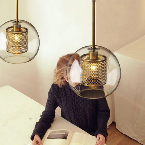Two smoke glass globe pendants hanging above a table