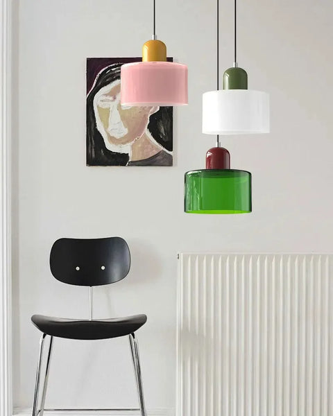Pink, white and emerald glass pendant lights in a room
