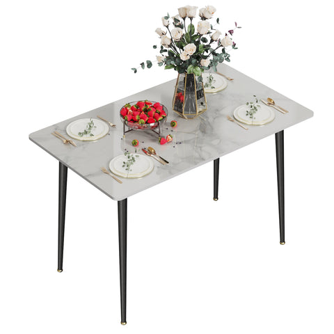 Gloss marble dining table in glossy white, laid with flowers