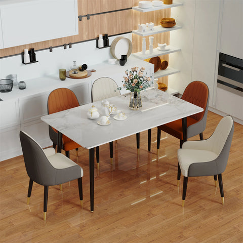 Gloss marble dining table laid with flowers and four chairs