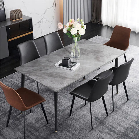 Gloss marble dining table with black legs and upholstered chairs