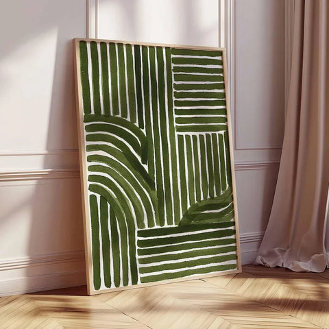 Abstract green and white artwork on a wooden floor with a light-colored wall and curtain in the background