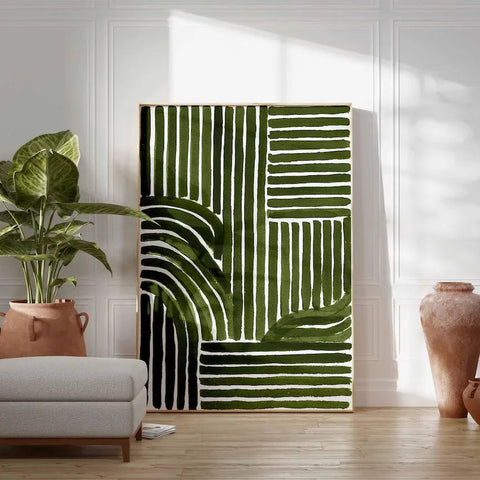 Room interior with a green and white abstract wall art piece, potted plant, and vases.